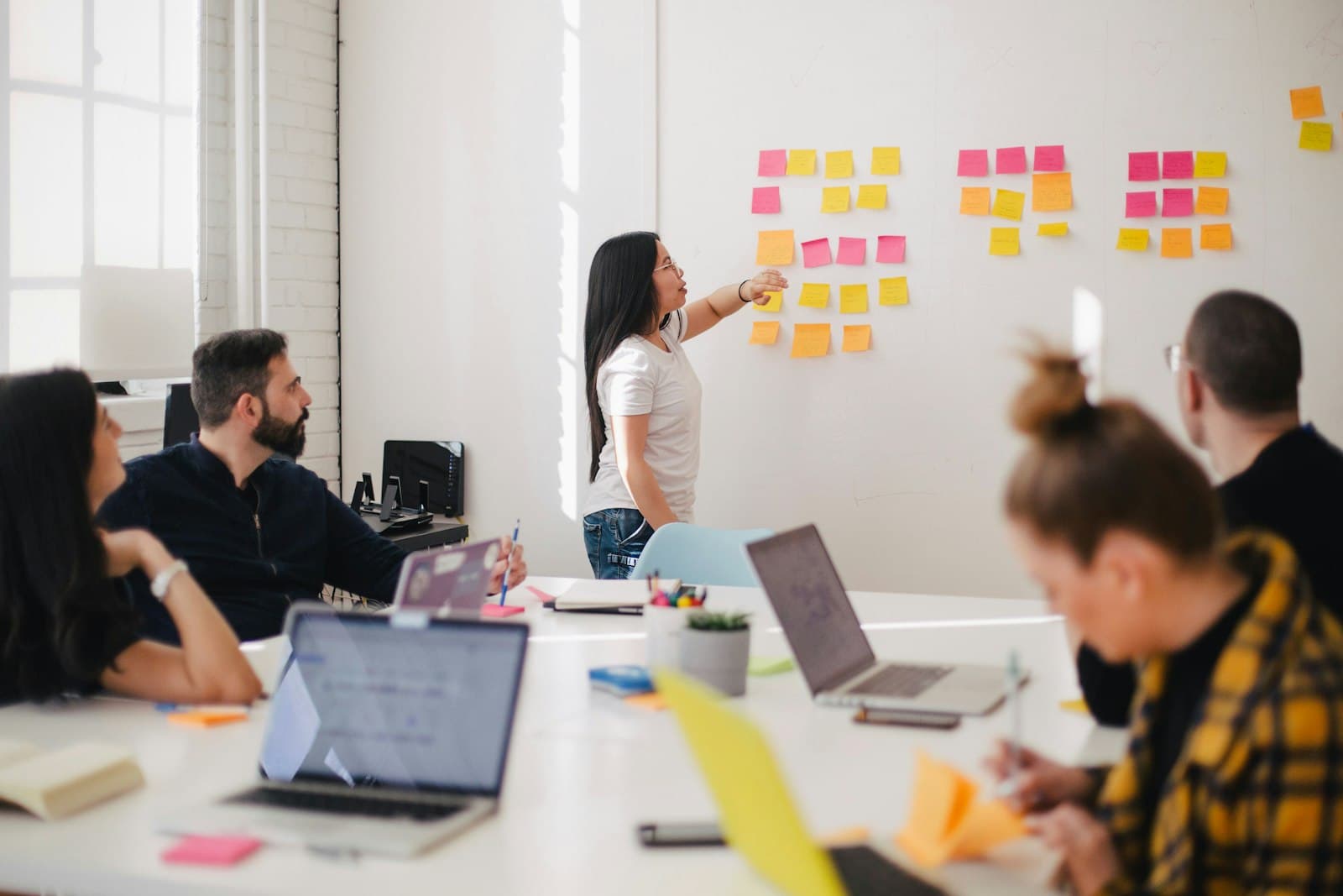 A team in discussion around a table in a bright meeting room